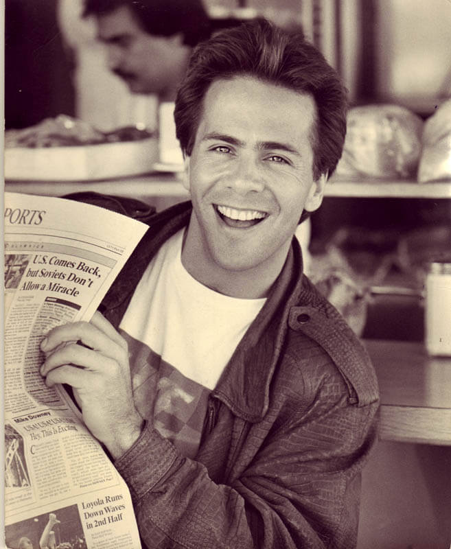 Jim Jarrett NY Headshot with newspaper